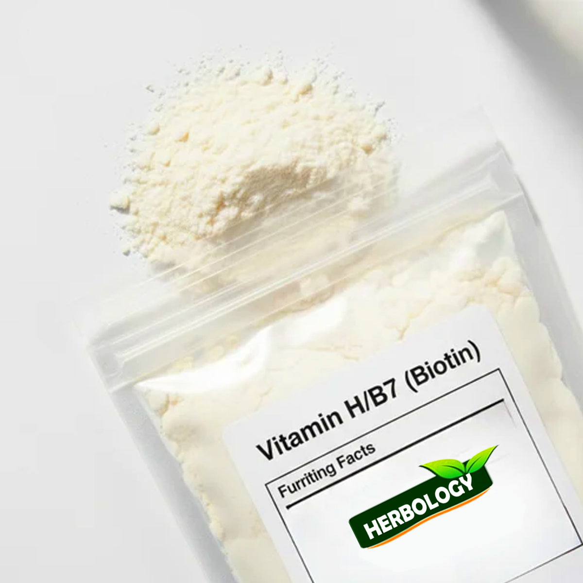 A clear stand-up pouch containing a white powder labeled 'Vitamin H/B7 (Biotin)' with the brand name 'HERBOLOGY' visible on the front label. A small pile of the same powder is placed above the pouch on a clean white background.