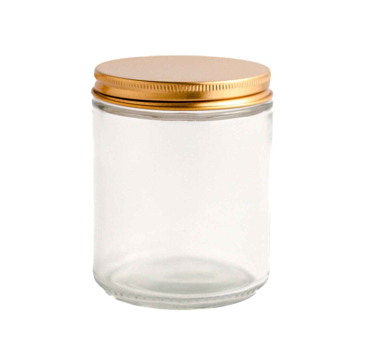 Transparent glass jar with a gold lid on a white background
