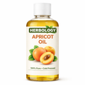 Bottle of Herbology apricot oil with a white background