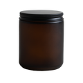 Amber glass jar with a black lid on a white background