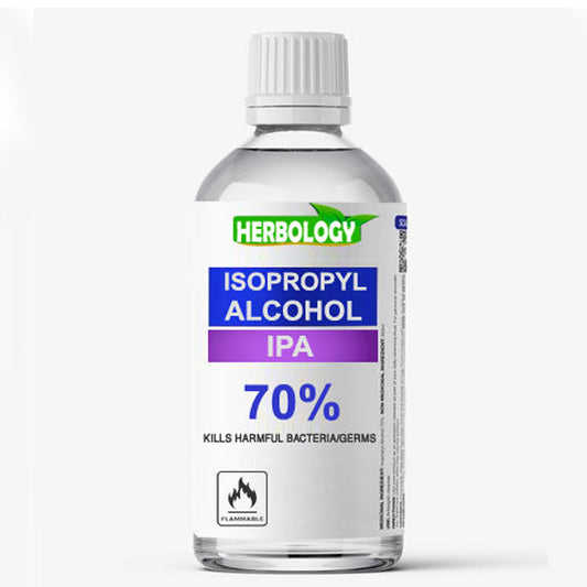 A bottle of Herbology Isopropyl Alcohol IPA 70% on a light gray background. The bottle is clear plastic with a white ribbed cap and a white label featuring blue and purple text blocks and a green Herbology logo.