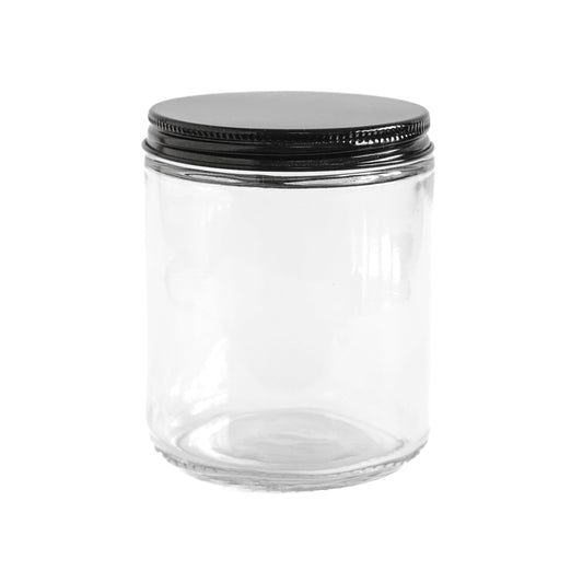 Clear glass jar with a black lid on a white background